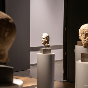 Stone busts on pedestals in a dimly lit gallery at the National Museum of Norway.