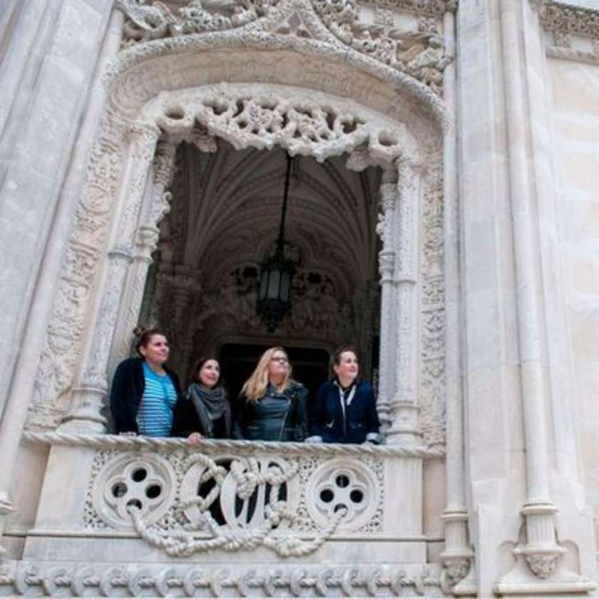 Guests looking out the window of a castle