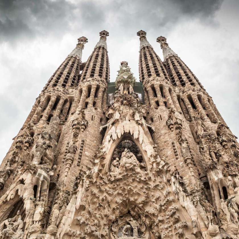 Image of Sagrada Familia from the front looking upwards