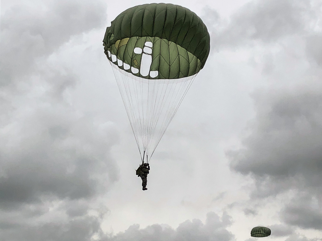 A parachutist dropping in over the Normandy beaches