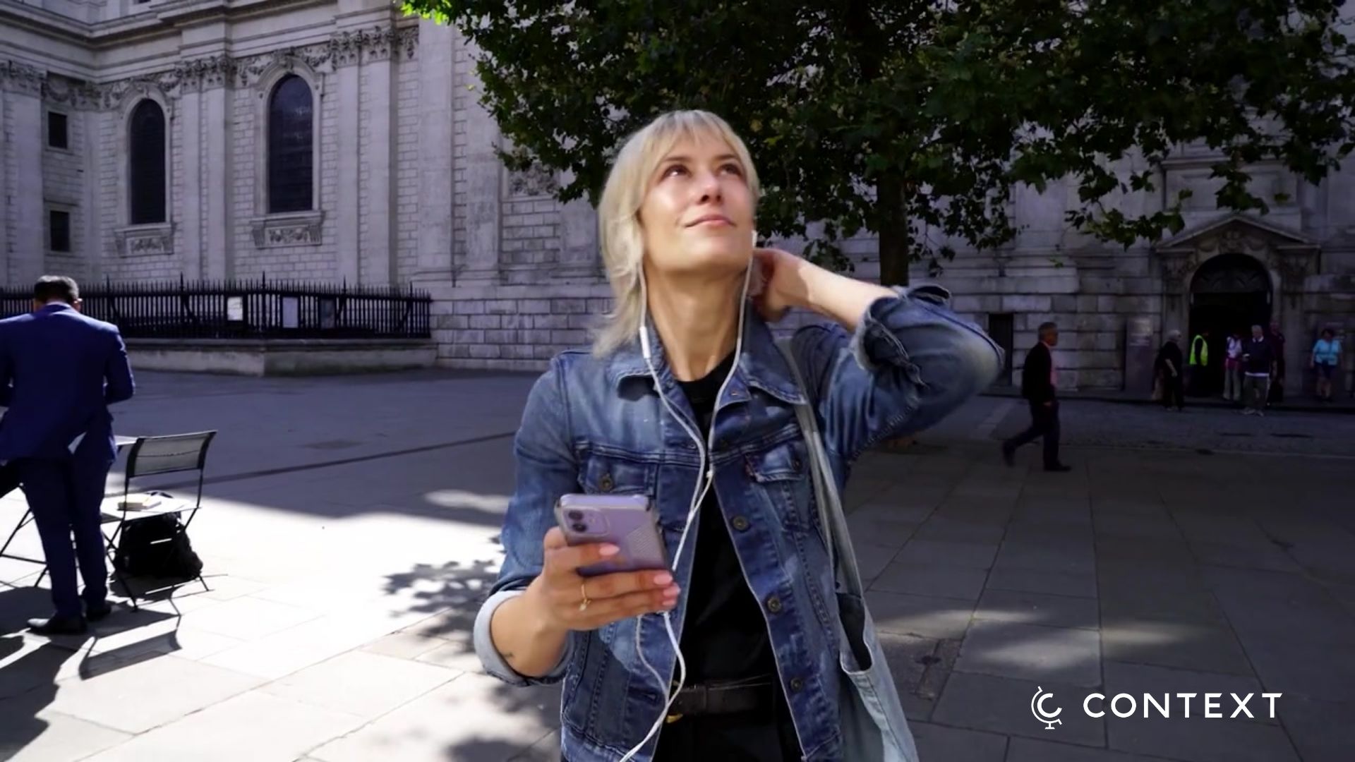 woman walking london listening to audio guide