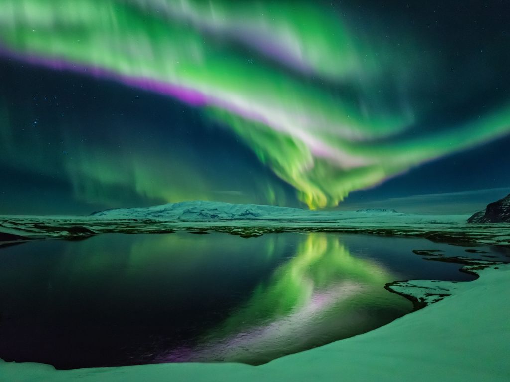 northern lights shine above iceland remote landscape