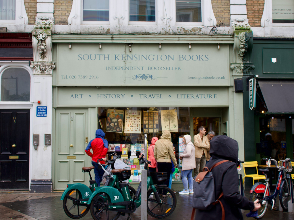 South Kensington bookshop with sage green storefront and people outside the front door. Part of our Read Watch Listen series in London.