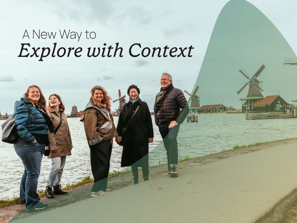 A group of travelers in Amsterdam, standing in front of windmills. A transparent green/yellow gradient overlay in a crescent shape is on the right side of the image.