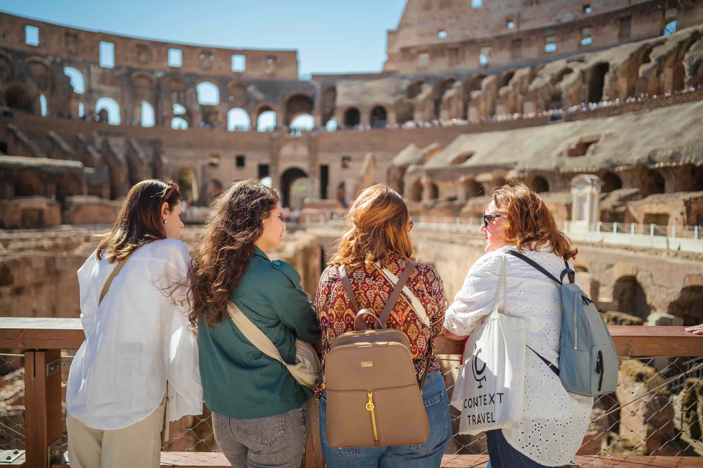 A Context Guide shows the wonders of the Colosseum to her group