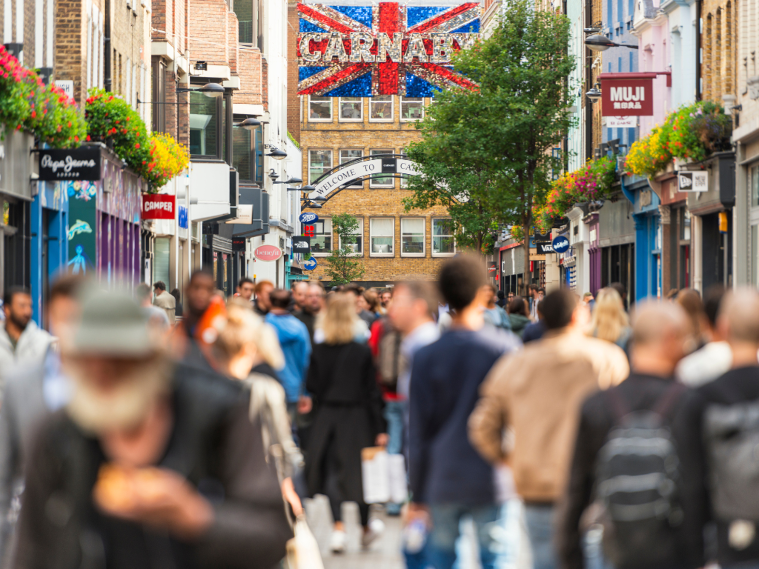 Shoppers walking through Carnaby Street, London