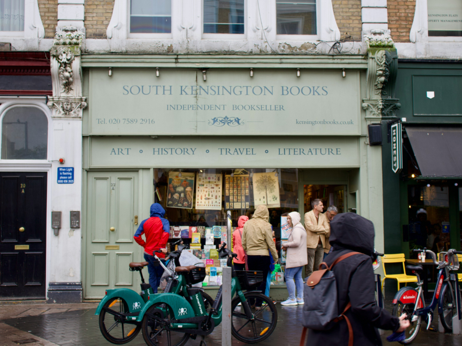 South Kensington bookshop with sage green storefront and people outside the front door. Part of our Read Watch Listen series in London.