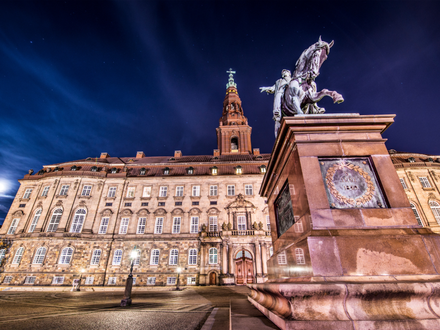 Christiansborg Palace with statue of horse in front, taken at an upward angle. 