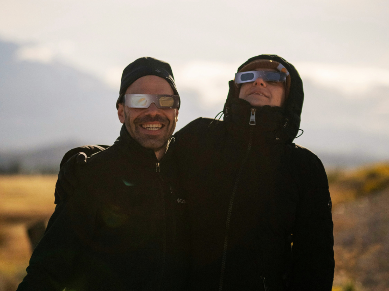 A couple viewing an eclipse with protective eyeware